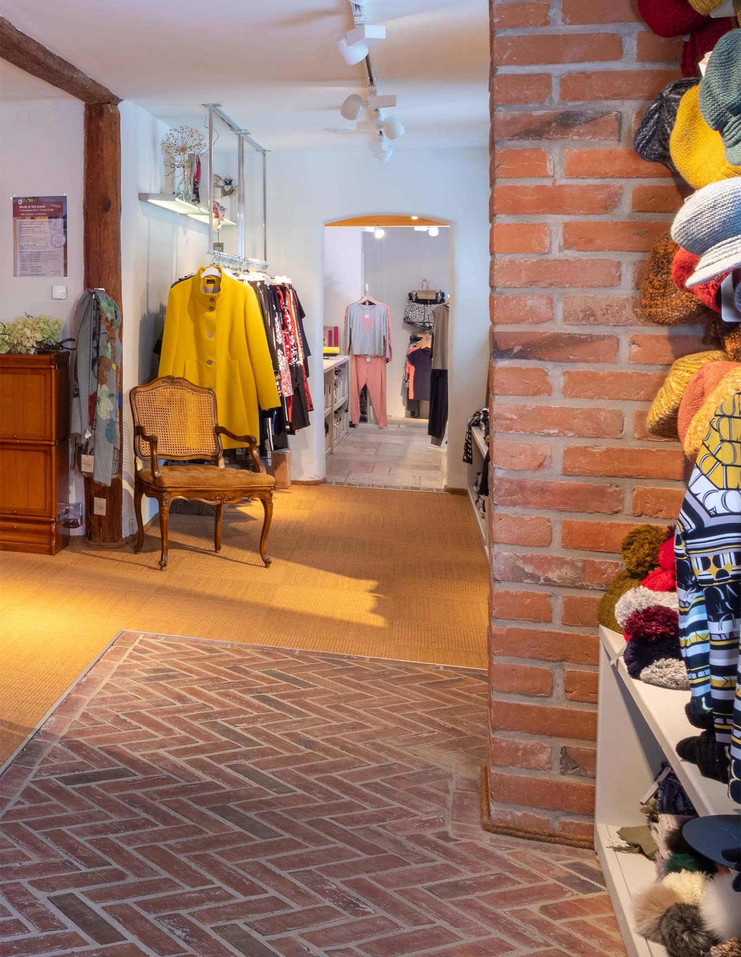 Ambientefoto: Blick in die Apart Boutique  mit gemauerter Wand und modischer Kleiderauswahl